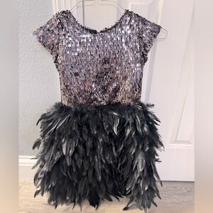 Girls fun and fabulous black sequined and feathered formal dress.